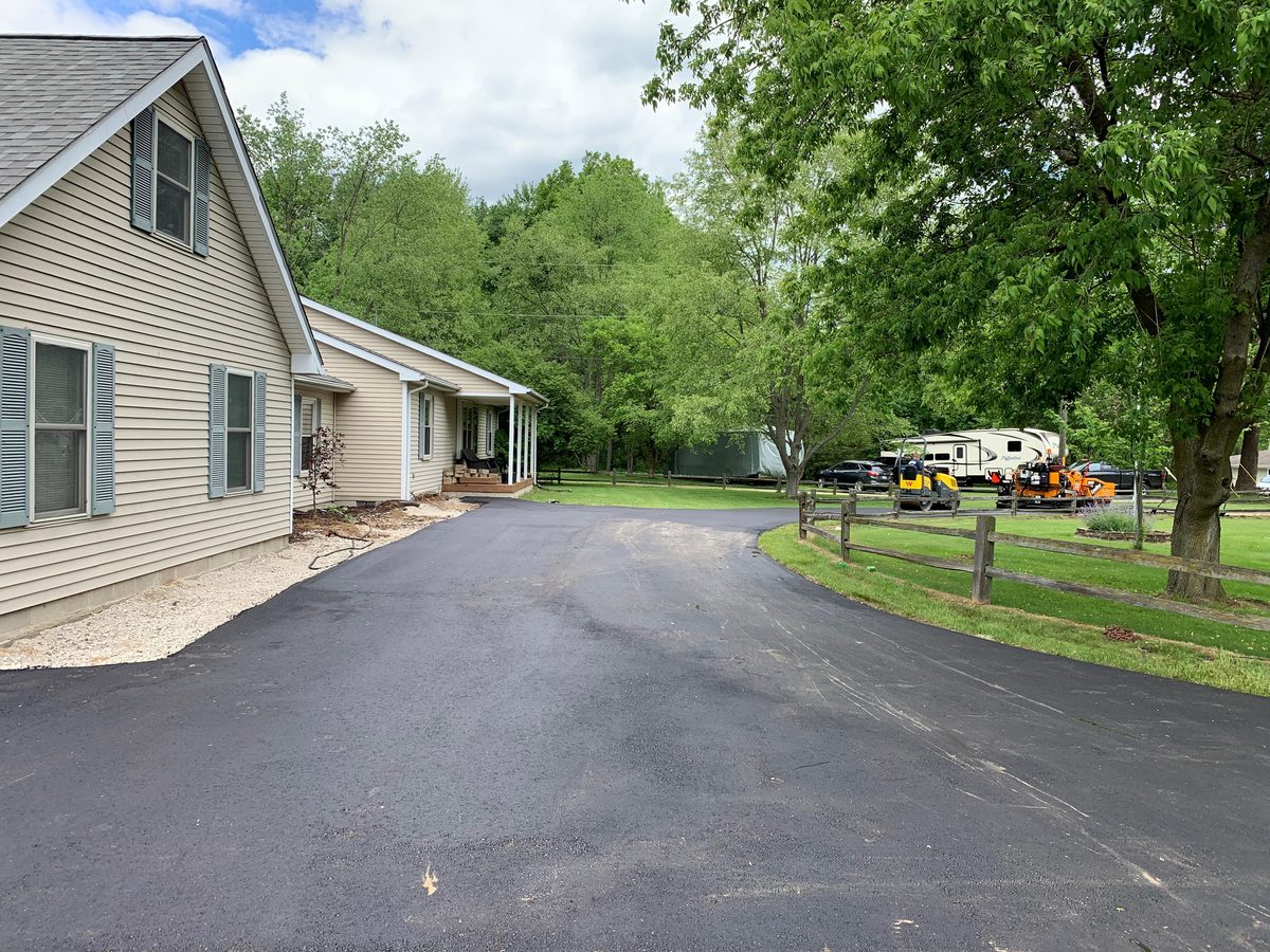 Wide finished asphalt driveway at a Michigan home