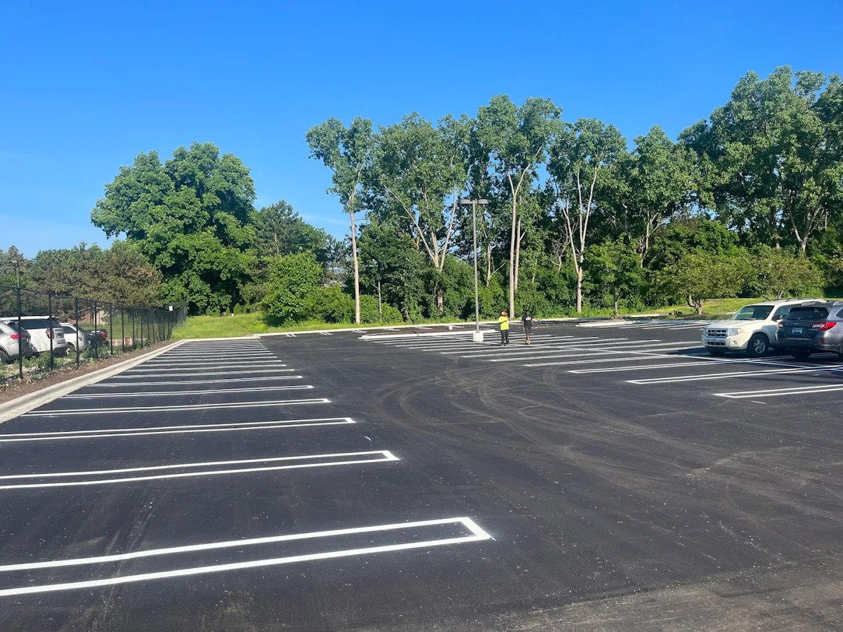Fresh yellow striping on a dark asphalt lot
