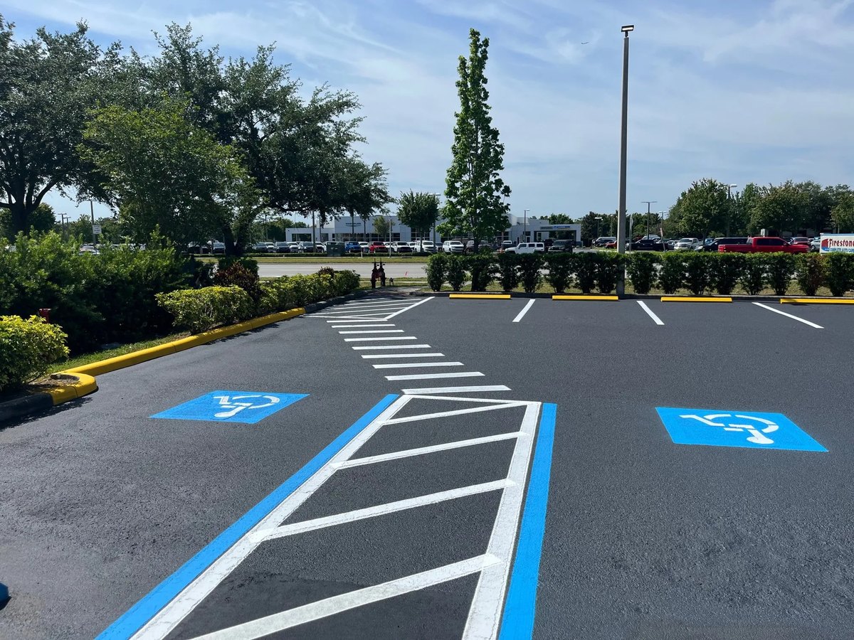 Freshly sealed parking lot with new ADA striping