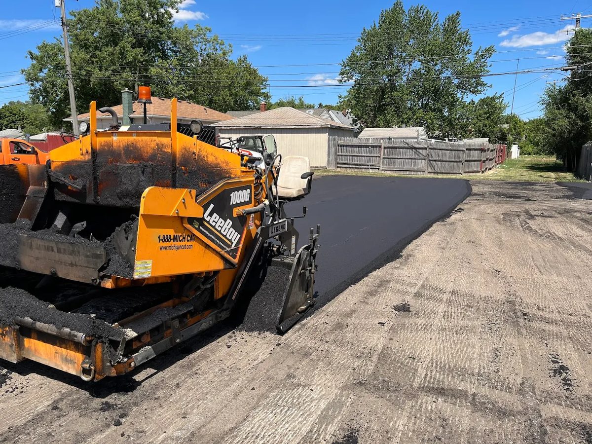 Crew patching a damaged asphalt section
